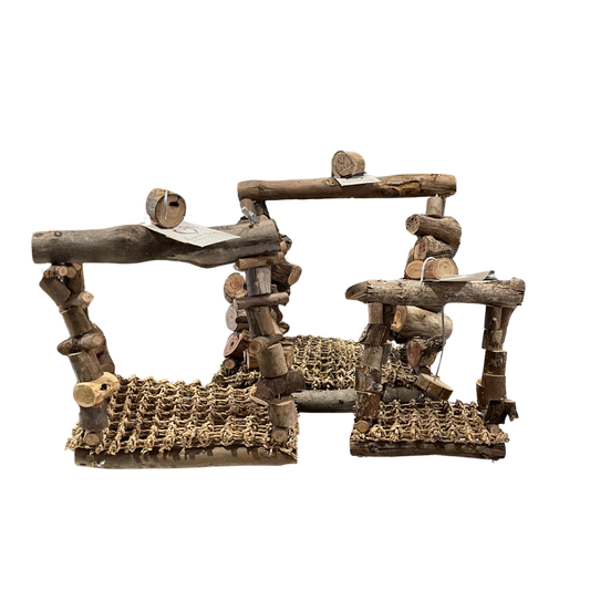 A rustic wooden bridge or hut made from natural branches and logs, featuring a jumping platform with chain-link flooring, a horizontal log beam, and a climbing frame, isolated on a white background.