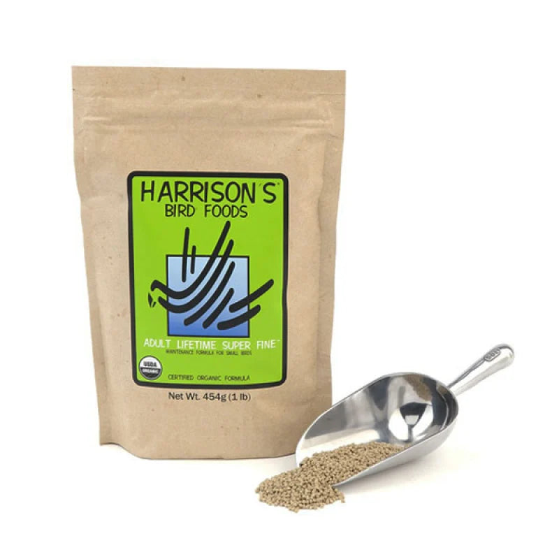 A stand-up kraft paper pouch of Harrison's Bird Foods adult lifetime super fine bird seed, shown next to a metal scoop filled with the light brown bird seed on a white background.