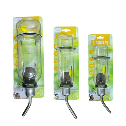 Three packaged pet water bottles in different sizes on a plain white background. The bottles are clear glass with metal nozzles and yellow accents, mounted on green and yellow retail cards labeled PIP squeak.