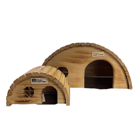 Two small wooden burrow-style animal houses with arched roofs and dark entry openings, shown on a plain white background. One house has a visible label reading 'Primary Wood Articles' and the other reads 'Petition Wood Arrows'.